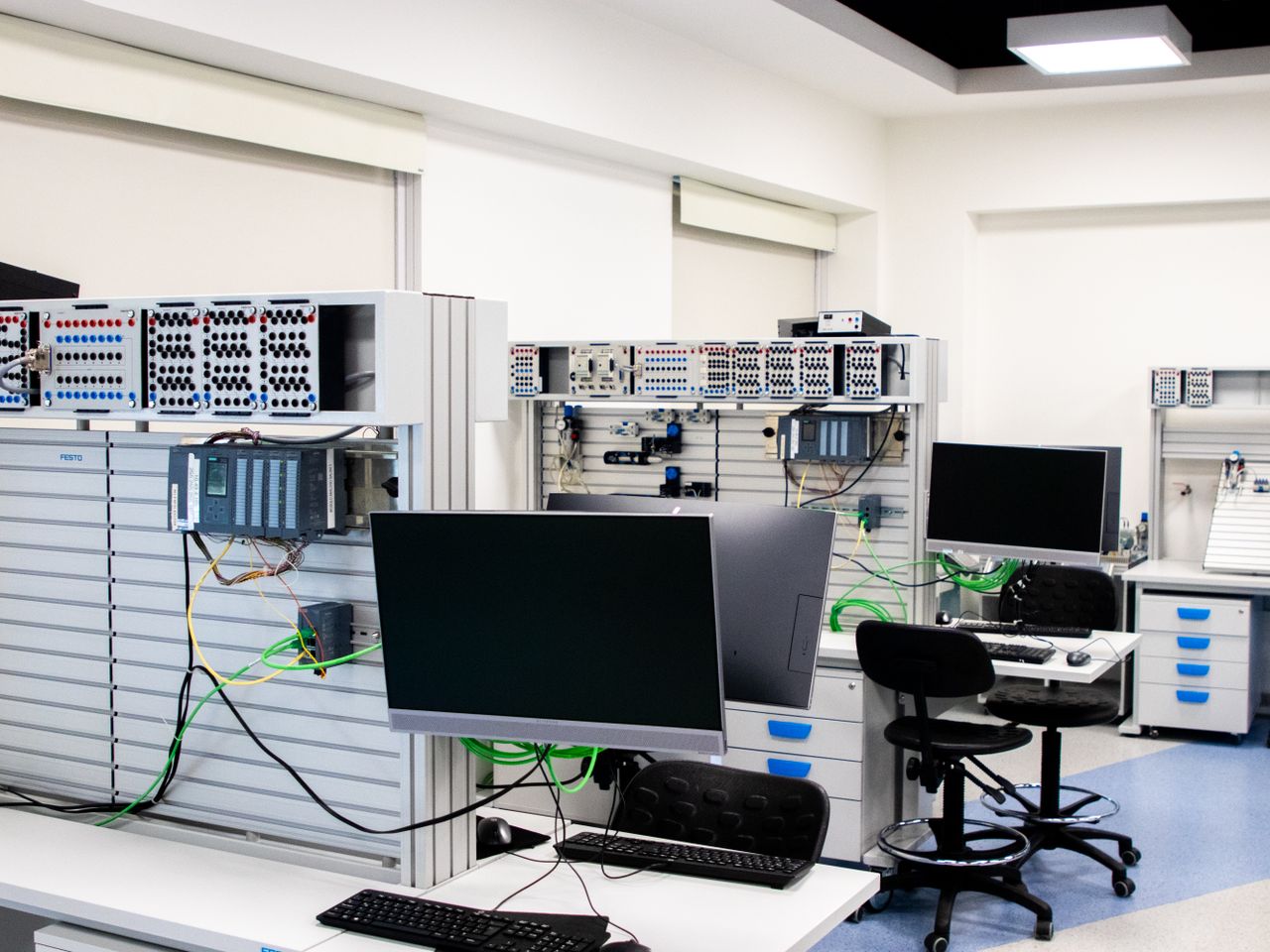 gallery-1 A contemporary computer lab with advanced workstations and electronic equipment, perfect for research and development.