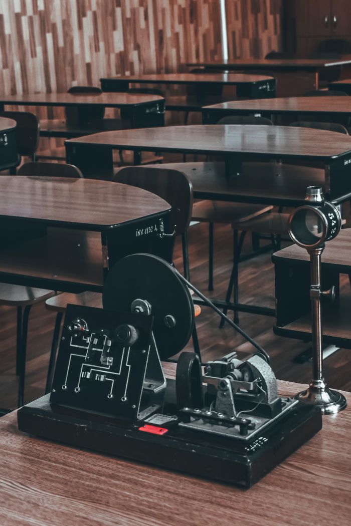 why-choose-us From above of retro dynamo electrical generator with Faraday disc placed on wooden table in classroom